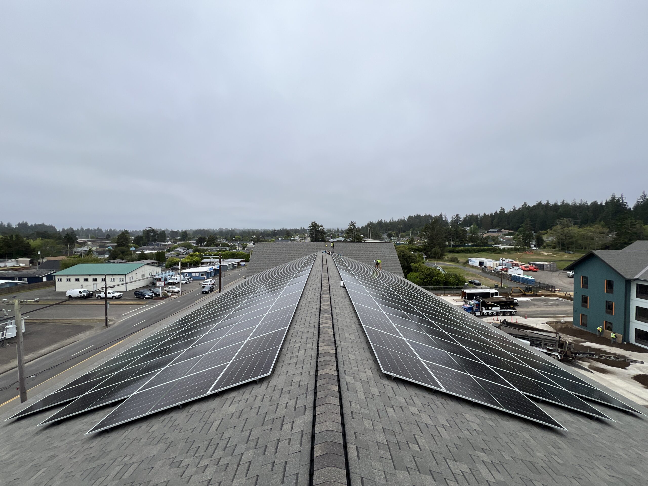 Large commercial rooftop solar array installed on a multifamily or commercial building with rows of photovoltaic panels.