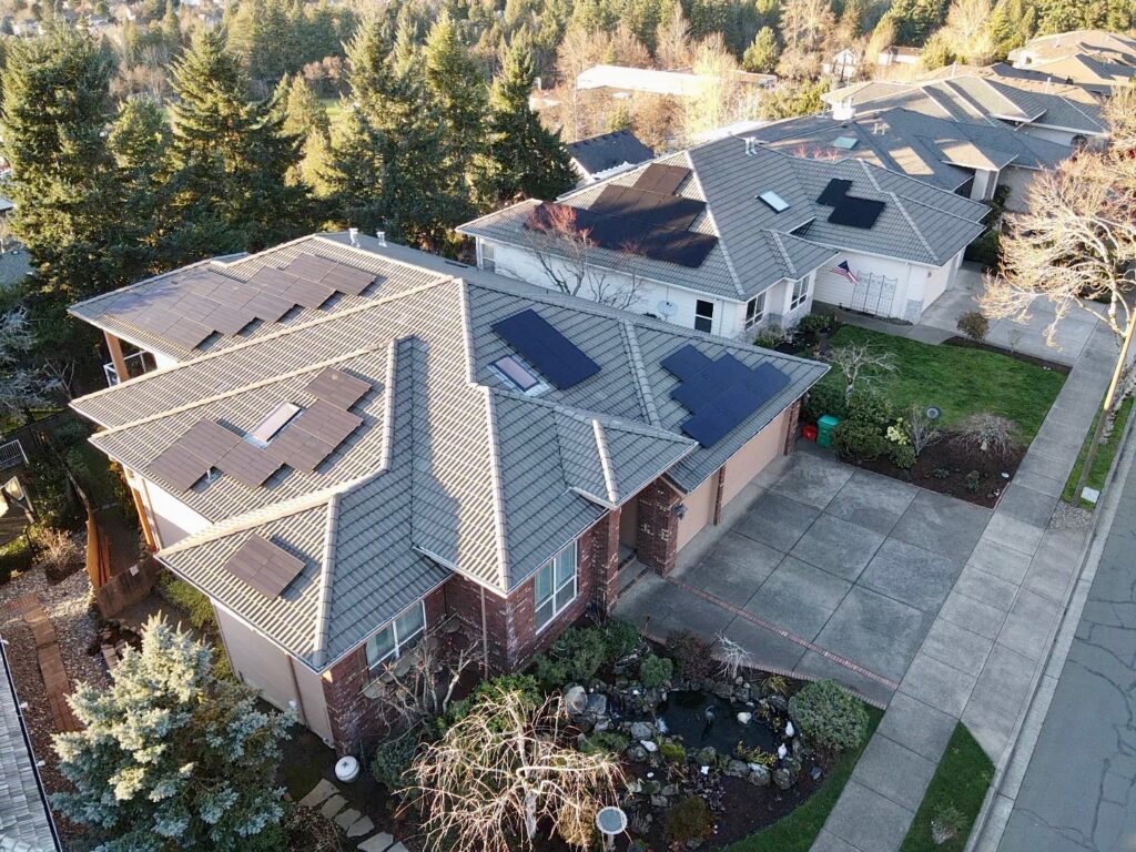 Aerial view of neighboring Oregon homes with rooftop solar panel systems.