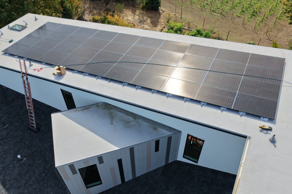 Solar panels mounted on a TPO roof using an attached racking system designed to minimize roof penetrations.
